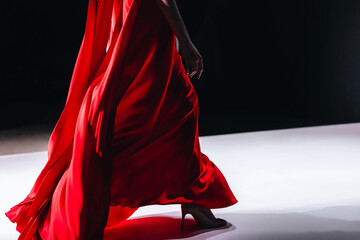 Beautiful elegant details of a bright red long silky skirt. Women's fashion