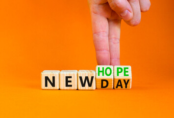 New day and hope symbol. Concept word New day New hope on beautiful wooden cubes. Beautiful orange table orange background. Businessman hand. Business new day and hope concept. Copy space.