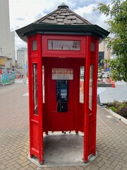 Vintage red wooden telephone booth on the street in Christchurch New zealand