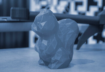 Abstract art object printed on 3D printer. Blue creative model squirrel printed on 3D printer from molten ABS PLA plastic filament. Object printed FDM printer. Additive progressive modern technology - obrazy, fototapety, plakaty