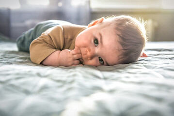 Cute baby boy resting on the bed