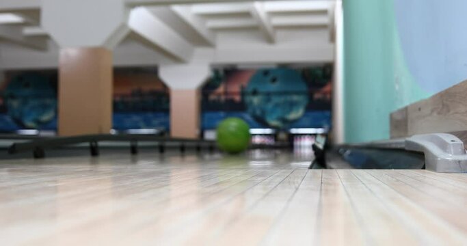 A blurry video image of a colorful bowling arena with a bokeh effect. The concept of blurred background, competitions, hobbies, teams, defocusing