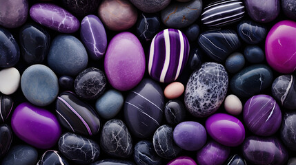 Obraz na płótnie Canvas Top view, a banner on which purple and black pebbles of different shapes and textures are successfully combined, creating a magical background, striking in its naturalness and aesthetics.