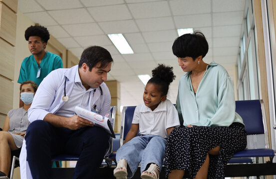 A male doctor is asking for information from a sick girl who came to the hospital.