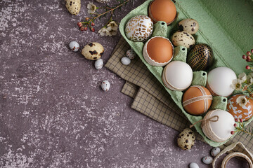 Fototapeta na wymiar Paper holder with traditional decorated Easter eggs and spring flowers on grunge background