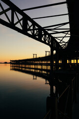 Fototapeta premium Sunset at The Rio Tinto Pier (Muelle de Rio Tinto) in Huelva, Andalusia, Spain