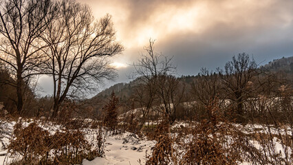 Fototapeta na wymiar Winter views of the Poprad Landscape Park on the Poprad River in the Beskid Sadecki mountains.