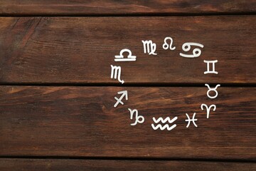 Zodiac signs on wooden background, flat lay. Space for text