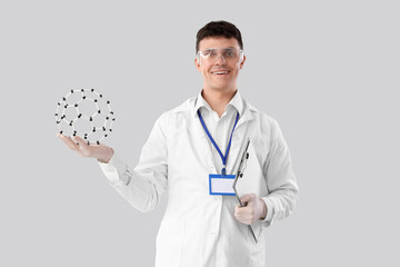 Male chemist with molecular model and clipboard on light background