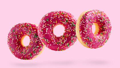 Pink donuts fly over pink background.