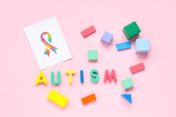 Word AUTISM, children toys and awareness ribbon on pink background. Concept of autistic disorder