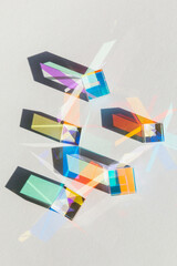 Glass geometric cube prism with light diffraction of rainbow spectrum colors and complex reflection...