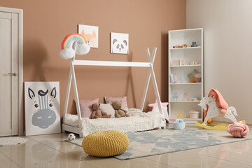 Interior of modern children's room with comfortable bed near color wall