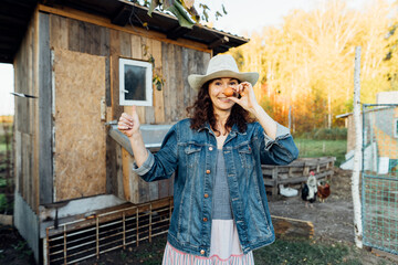 With a beaming smile, a hobby woman farmer displays a perfect egg Delightful farm scene as a cheerful woman showcases her freshly collected egg Sustainable lifestyle, organic farmer,