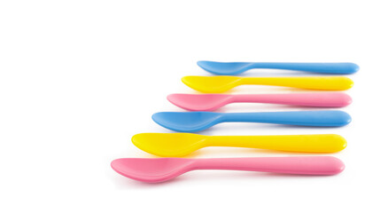 Set of colourful children plastic spoons graduated graphic side view white background. Concept of reusable plastic utensils, kids parties lunch dinner, sustainable living, child friendly, food
