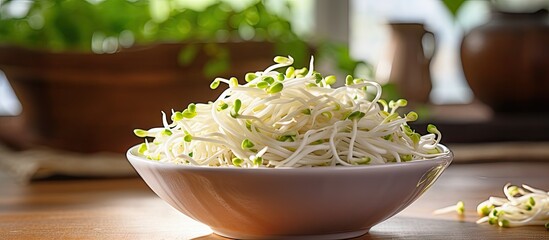 Bowl of sprouts and watercress with raw mung bean sprouts on table