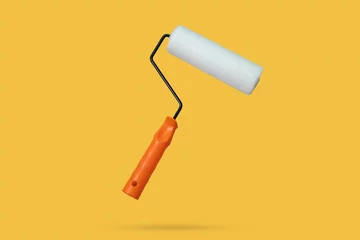 Tuinposter white paint roller floated on yellow background © Piman Khrutmuang
