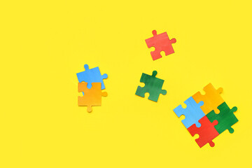 Color puzzle on yellow background. Concept of autistic disorder