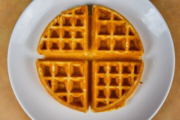 Golden-Brown Waffle on White Plate, Top-Down View