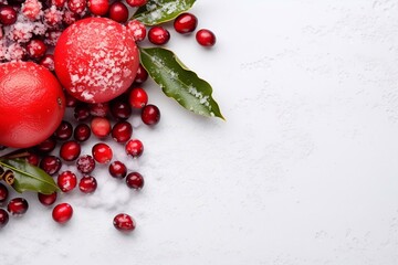 Pomegranate and viburnum rowan berries on a white table with snow, Christmas background