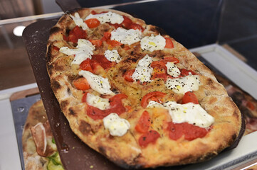 Italian typical specialty food pizza on display close up view