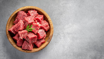 raw meat, raw beef. top view of Raw beef meat chopped in cubes on concrete table, copy space