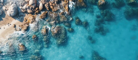 Aerial view of boat and rocks in beach water - Powered by Adobe
