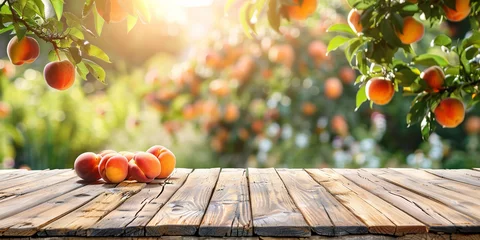  Empty wooden kitchen table over peach fruit garden background © Ricardo Costa