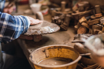 Hands molding clay in a clay workshop to teach people how to mold the material to create figures