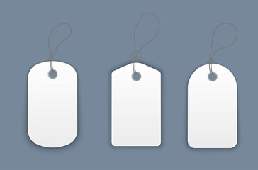Blank white paper price tags or gift tags in various shapes. Set of labels with cord.