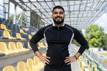 Confident athlete standing in an empty stadium