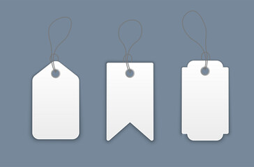 Blank white paper price tags or gift tags in various shapes. Set of labels with cord.