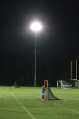 Lacrosse goalie at night