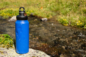  Eco-Friendly Blue Water Bottle Near Natural Stream with Butterfly - 763379268