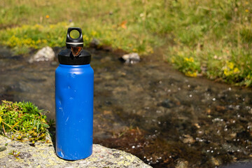 Eco-Friendly Blue Water Bottle Near Natural Stream with Butterfly - 763379271