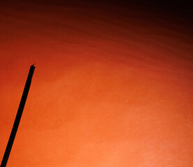 A silhouette of fume on the wavy orange background