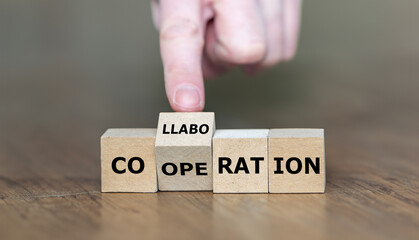 Wooden cubes form the words cooperation and collaboration.