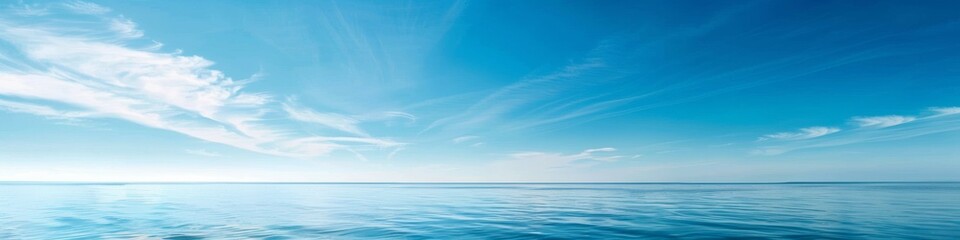 Fototapeta na wymiar A clear blue sky over a calm sea, offering a vast expanse of water and sky for a tranquil summer backdrop with ample copy space