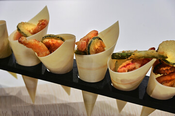 Healty fried veggies finger food in paper cone bags