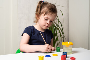 Child girl coloring hearts for World Autism Awareness Day. Autistic pride day concept.