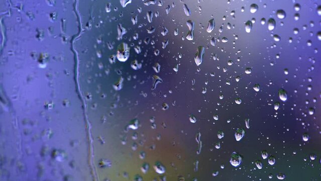 Raindrops on window with blurred background. Motion graphic
