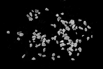 Table salt crystals on a black background.