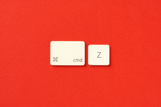 Concept of righting the wrongs of the past and undoing a previous action with Command Z buttons on red background
