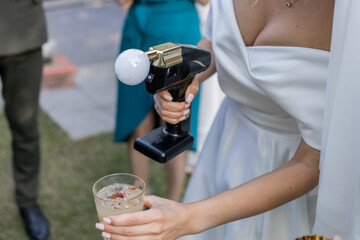 bartender shows at a wedding with a bride in a dress