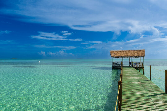 Pier of a hotel at Cayo Guillermo in the Jardines del Rey archipelago, with clear turquoise water and the horizon in the distance; Cayo Guillermo, Cuba