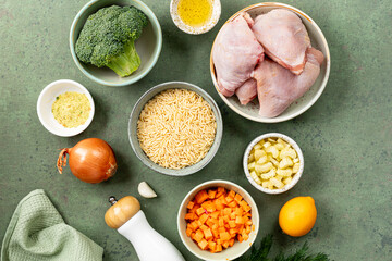 Ingredients for cooking chicken with orzo paste and vegetables.