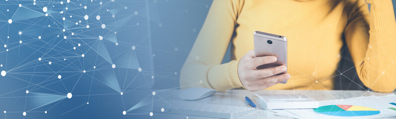 woman working in phone with computer in office