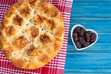 Ramadan Iftar Table.Traditional Foods Dates (Hurma) and Turkish Pita (Ramazan Pidesi) of Ramadan Feast Celebrations, Eid al-Fitr Concept Üsküdar Istanbul, Turkiye (Turkey) - obrazy, fototapety, plakaty