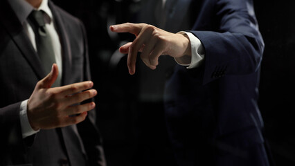 Businessmen work with a virtual close-up screen in a dark office