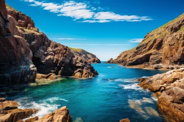 Fototapeta na wymiar Rocky coast under a clear blue sky background with rugged cliffs